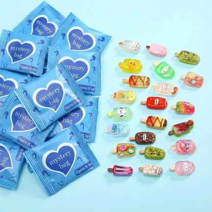 Blue mystery bags with assorted colorful mini ice cream popsicle charms