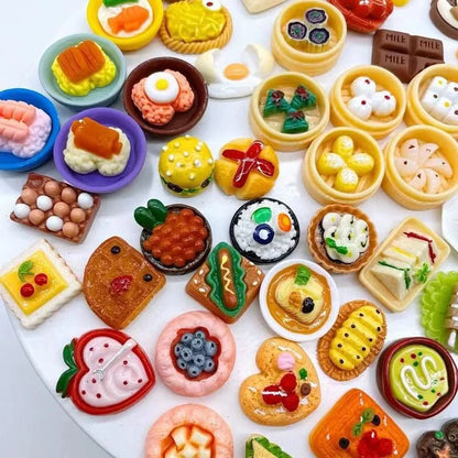 Assorted realistic miniature food and drink collectibles on a white background