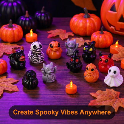 Halloween resin duck figurines displayed with pumpkins, candles and autumn leaves