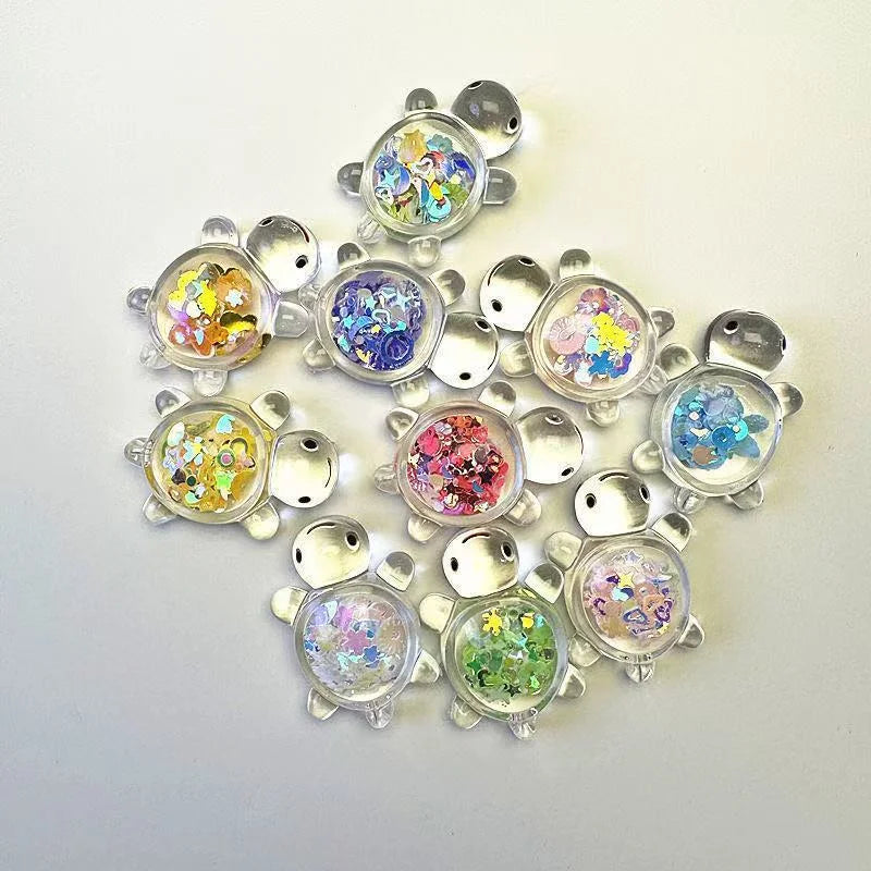 Assorted glitter turtle mystery bag figures arranged on a white background
