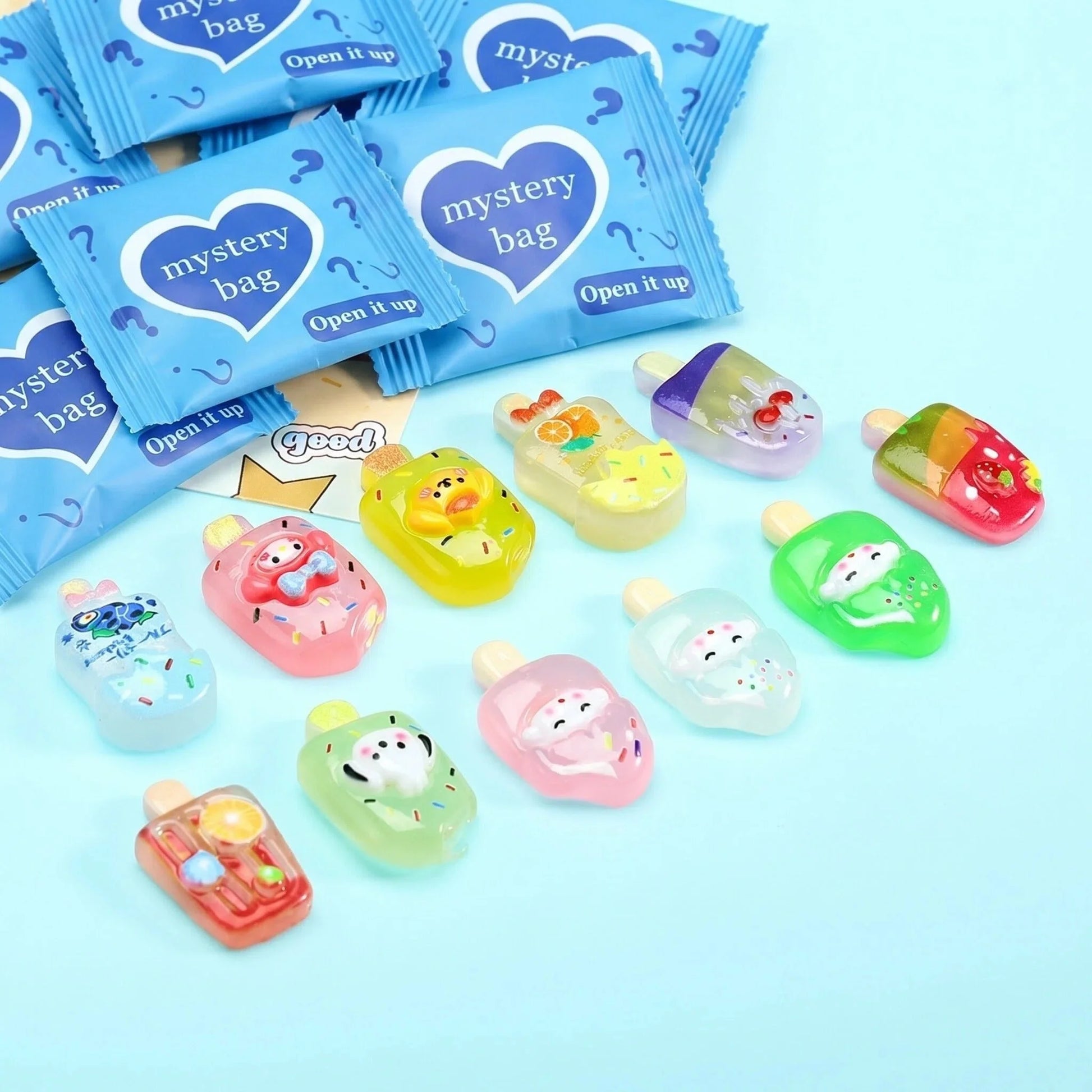Kawaii character popsicle charms displayed with blue mystery bags