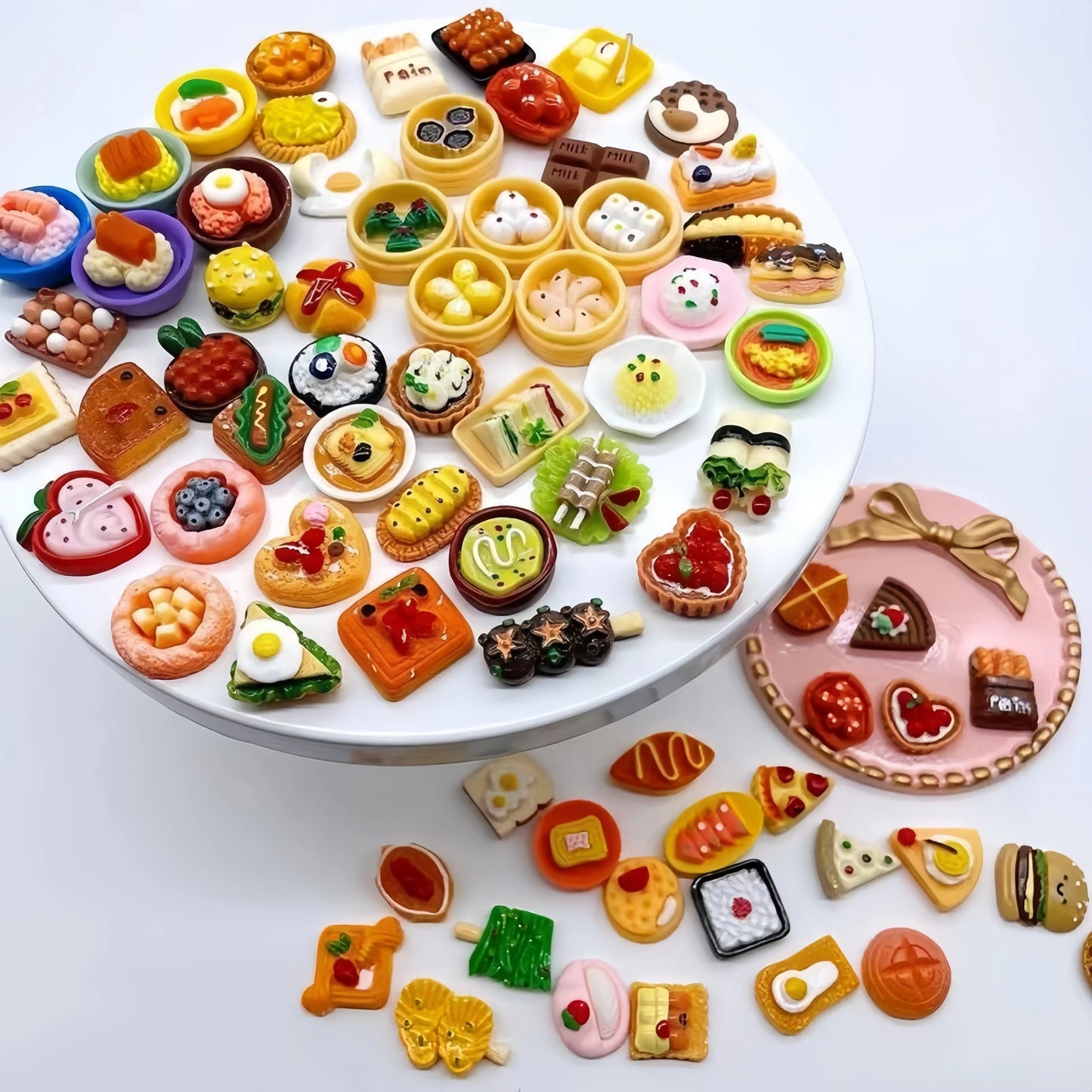 Miniature food charms arranged on a plate with a DIY bracelet