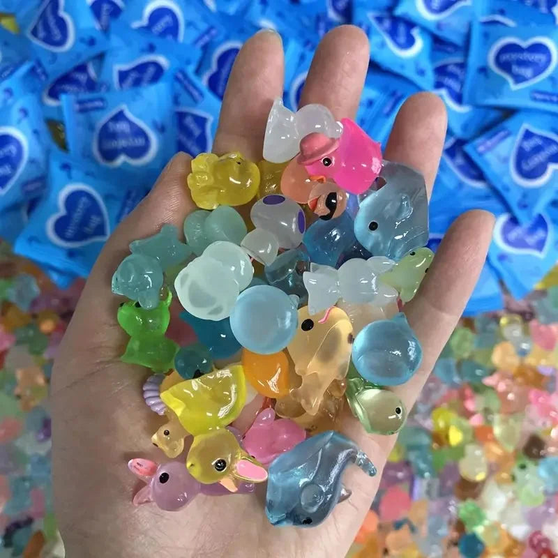 Close-up of assorted pastel mini resin animal figures displayed in a hand