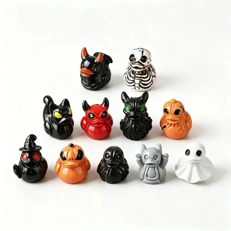 Eleven spooky resin duck figurines including ghosts, skulls, cats and demons