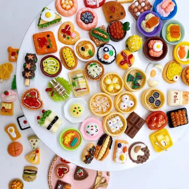 Colorful miniature meals, desserts and drinks displayed on a round tray