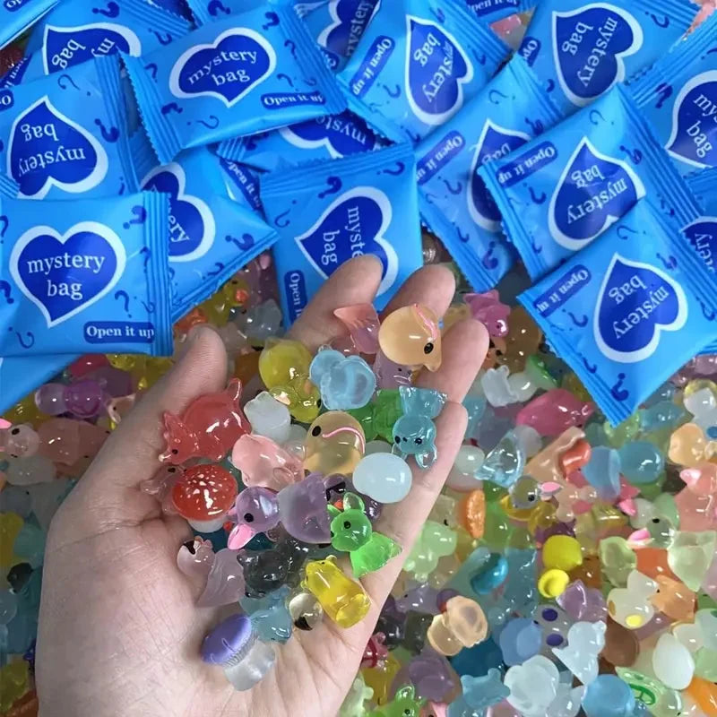 Assorted translucent mini animal figures held beneath blue mystery bags