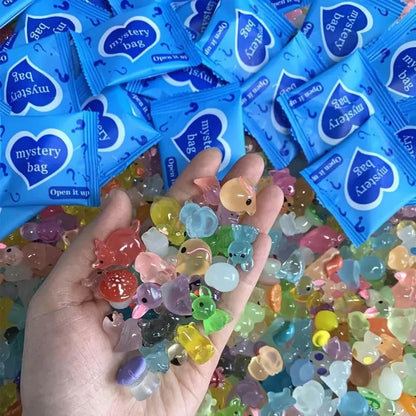 Assorted translucent mini animal figures held beneath blue mystery bags