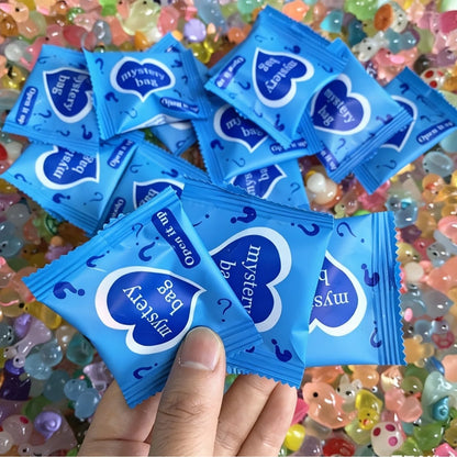 Multiple blue animal mystery bags displayed over colorful mini resin figures